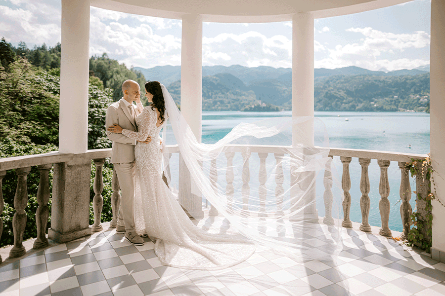 Wedding couple during their photoshoot on a famous balcony at Grand Hotel Toplice in lake Bled.