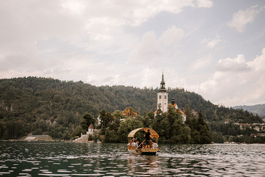Pletna boat drives wedding guests to lake Bled Island.