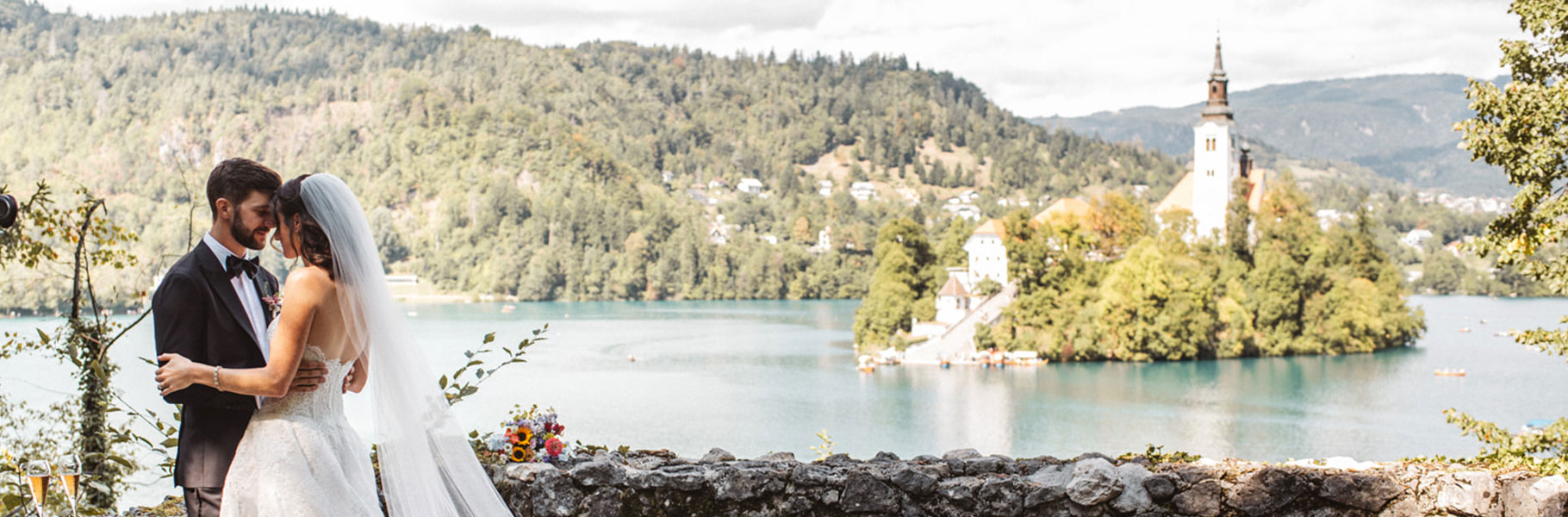Bride and groom overlooking Lake Bled and Bled Island church in Slovenia