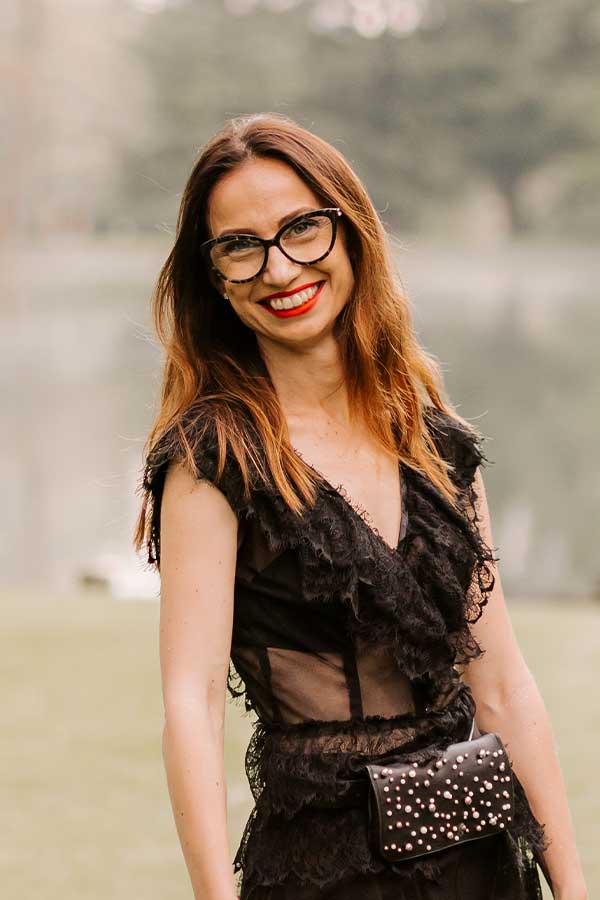 Petra Starbek, bespoke wedding planner in Lake Bled, Slovenia, smiling in an elegant black dress.