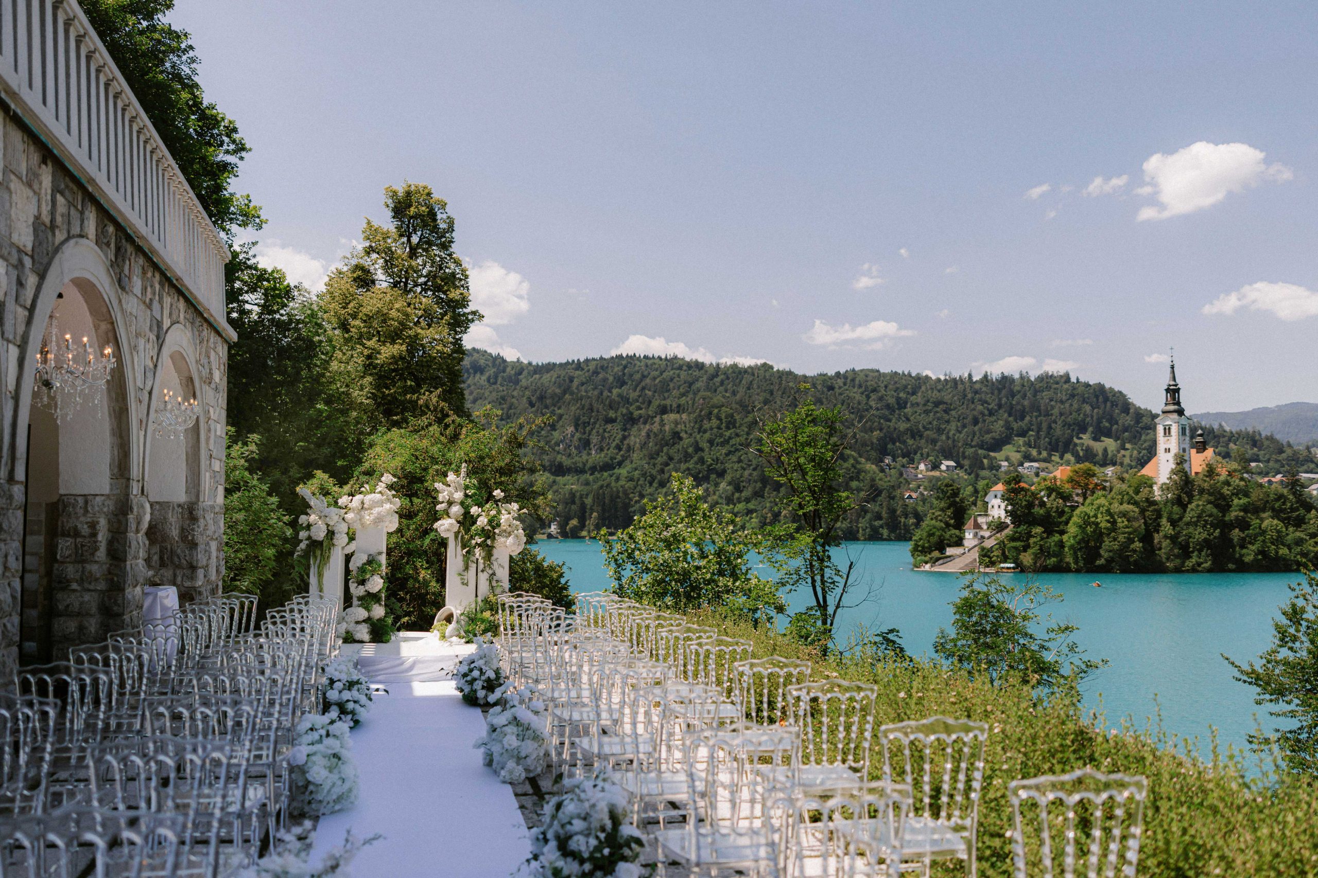 Private wedding ceremony setting at Vila Bled overlooking Lake Bled and Bled Island, planned by Petra Starbek.